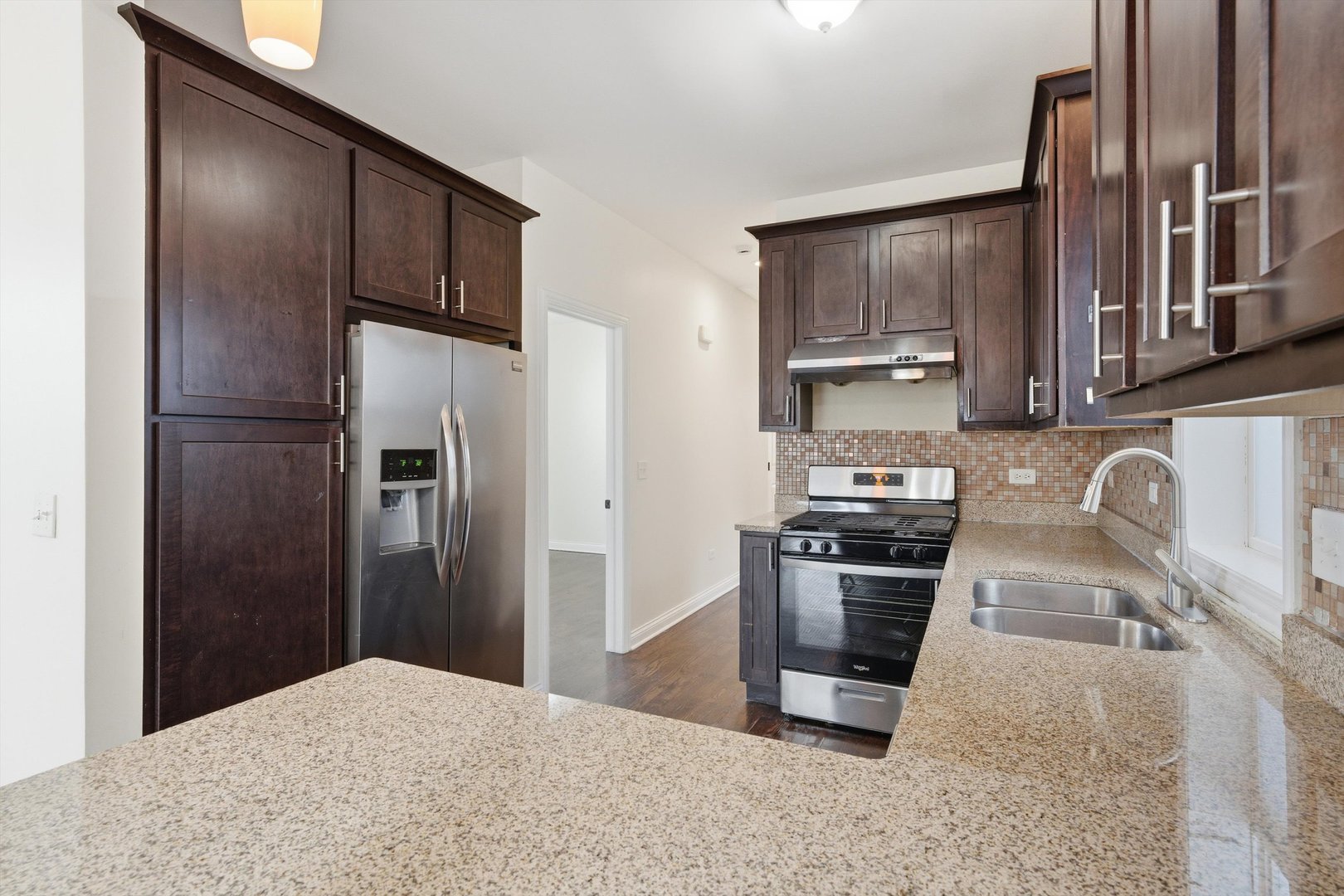 4063 South Rockwell Street Chicago, IL 60632 - Photo 9 of 24 a kitchen with stainless steel appliances granite countertop a refrigerator stove and sink