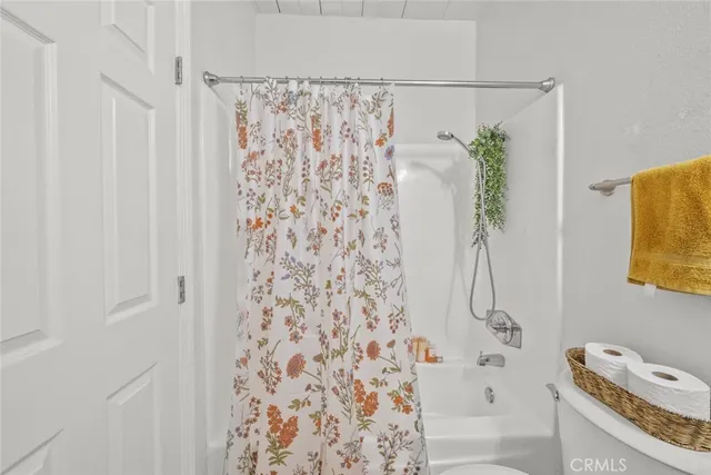 a bathroom with a shower curtain and a bathtub