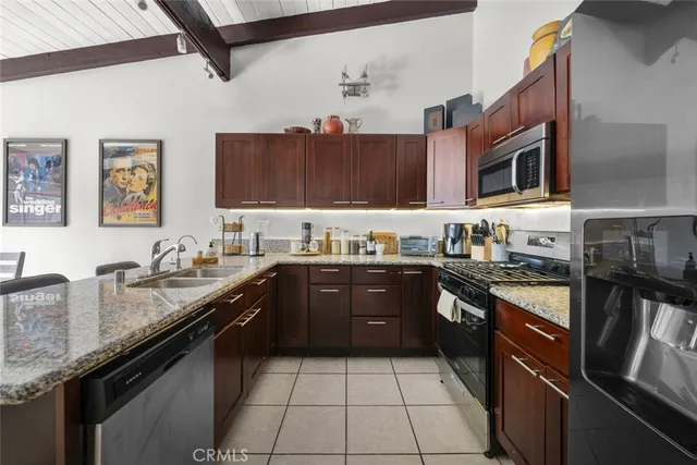 a kitchen with stainless steel appliances granite countertop a sink stove and oven