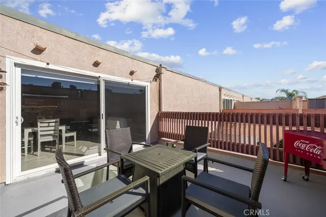 a view of a patio with a table and chairs