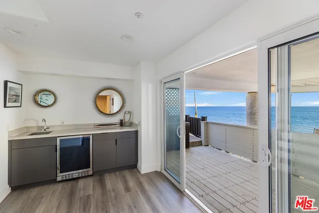 a view of a room with wooden floor and furniture