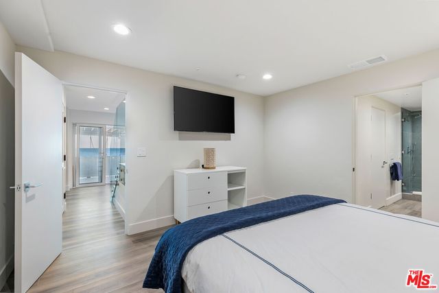 a view of residential houses with snow on the road