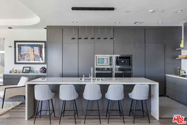 a kitchen with a dining table chairs and white cabinets