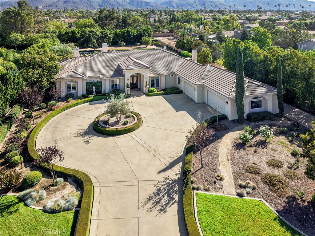 1662 Cherokee Road Corona, CA 92881 - Photo 2 of 60 a aerial view of a house with swimming pool and trees in the background