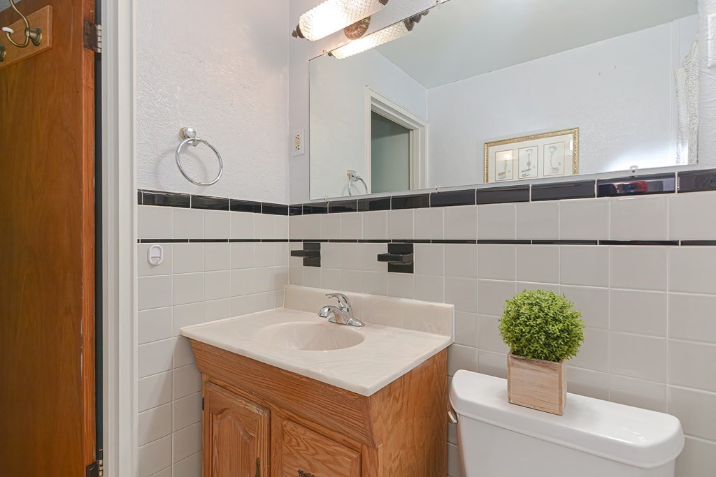 22 Grace Road Woburn, MA 01801 - Photo 21 of 36 a bathroom with a sink toilet and mirror