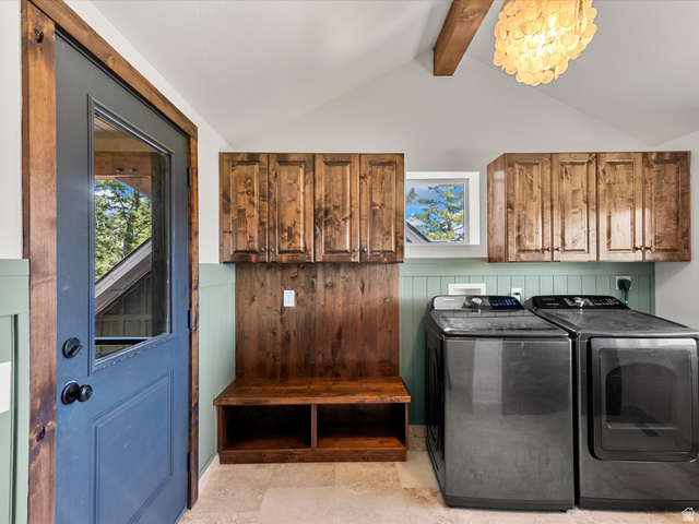 1225 Old Oregon Road Soda Springs, ID 83276 - Photo 17 of 67 Laundry room featuring natural wood cabinetry, wood paneling, and a built-in bench storage unit