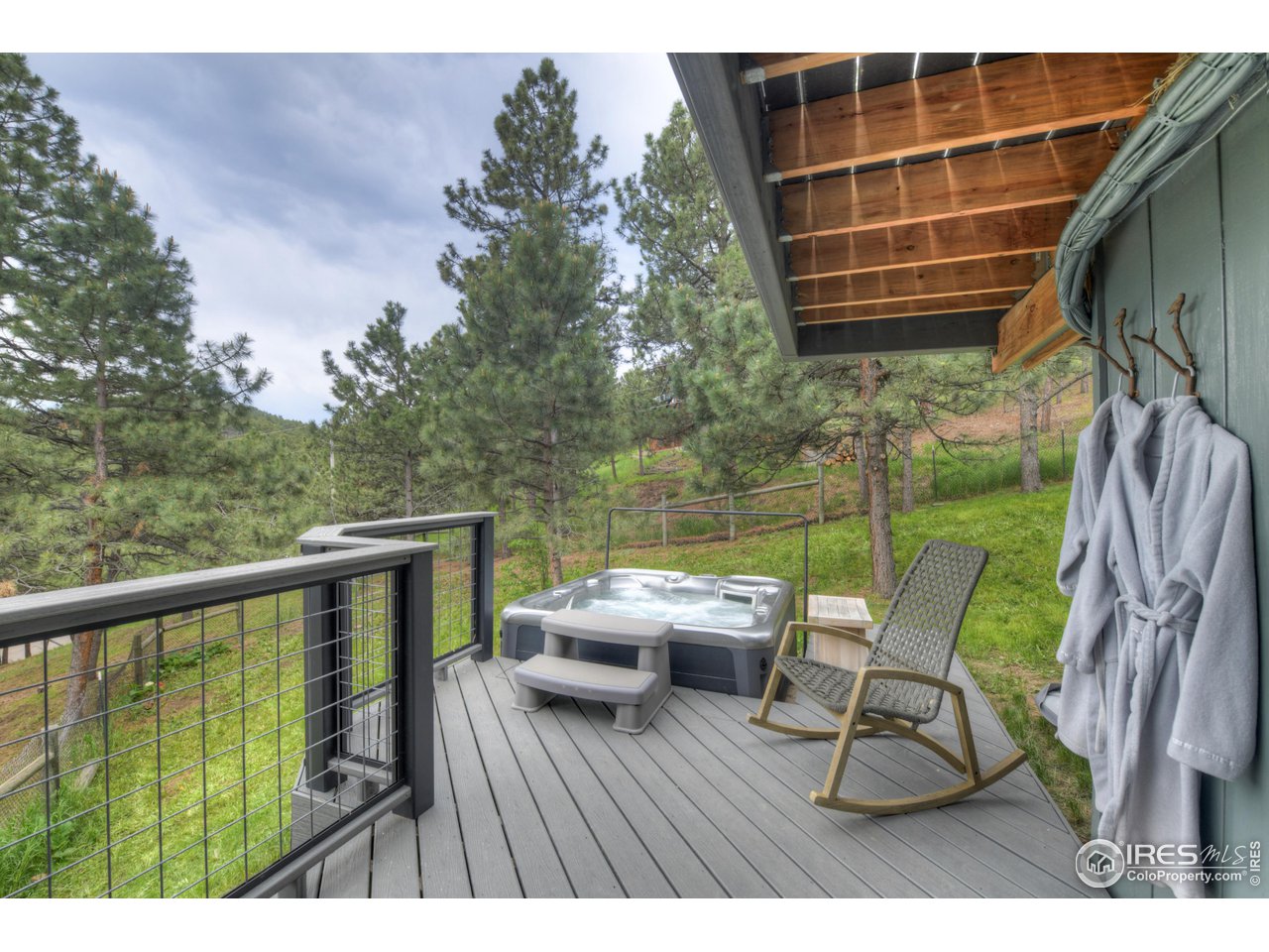 252 Pine Tree Lane Boulder, CO 80304 - Photo 13 of 39 a balcony with table and chairs