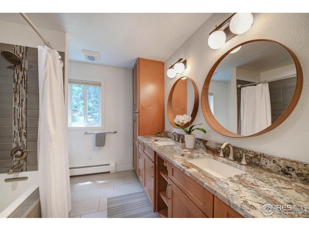 252 Pine Tree Lane Boulder, CO 80304 - Photo 17 of 39 a bathroom with a granite countertop double vanity sink and a mirror