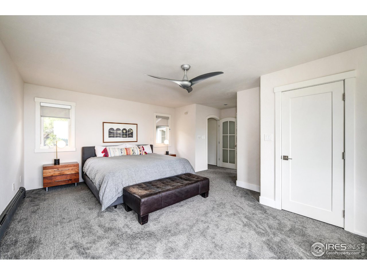 252 Pine Tree Lane Boulder, CO 80304 - Photo 18 of 39 a spacious bedroom with a bed and a ceiling fan