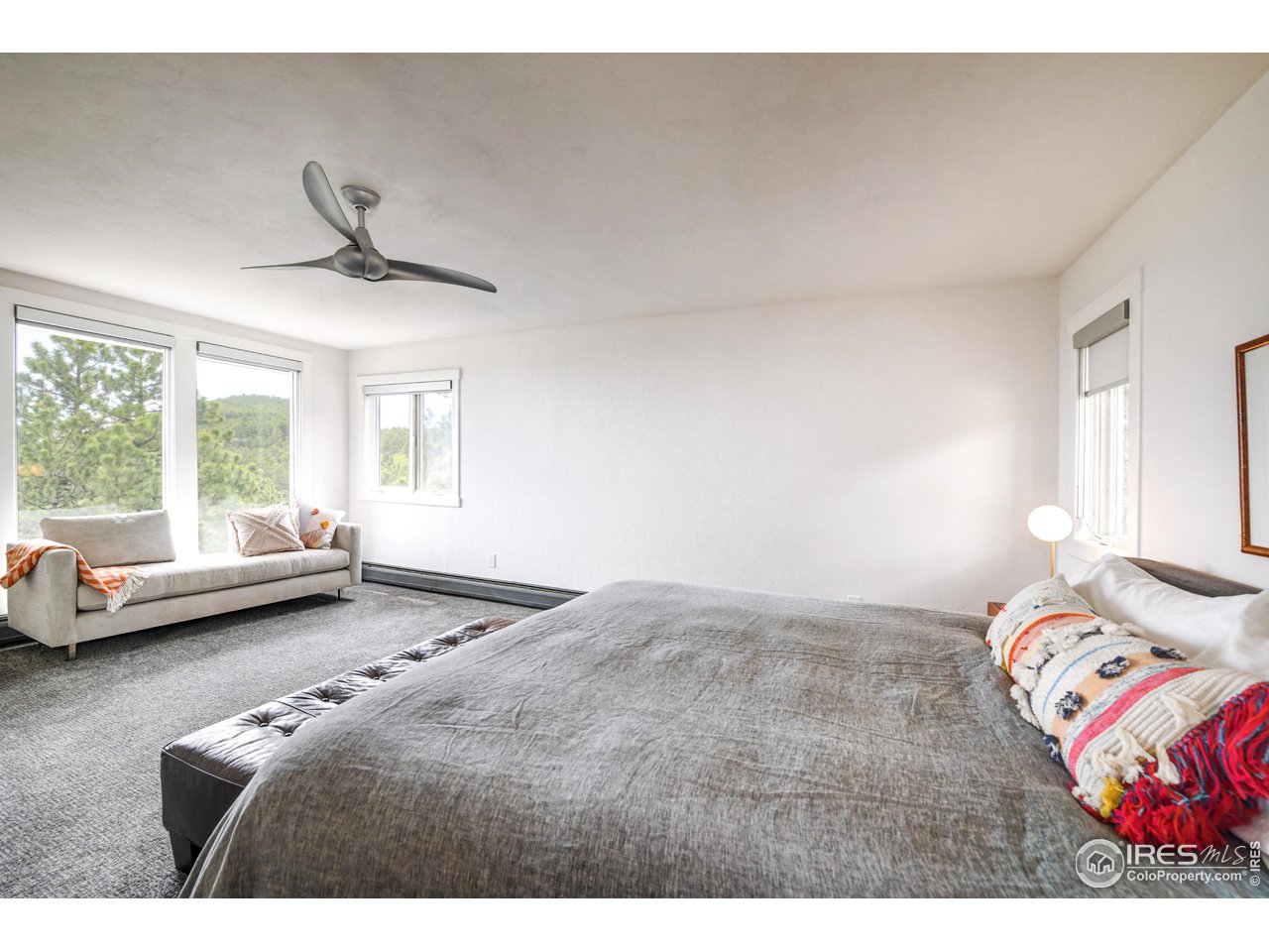 252 Pine Tree Lane Boulder, CO 80304 - Photo 19 of 39 a bedroom with a bed couch and a window