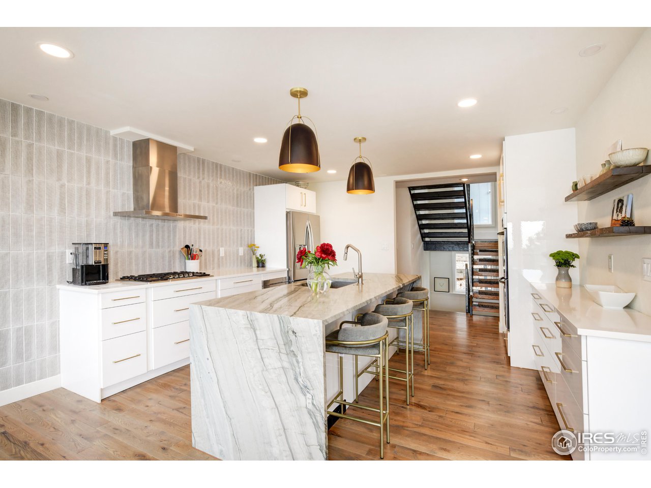 252 Pine Tree Lane Boulder, CO 80304 - Photo 8 of 39 a open kitchen with stainless steel appliances kitchen island granite countertop a stove a sink a refrigerator and white cabinets with wooden floor