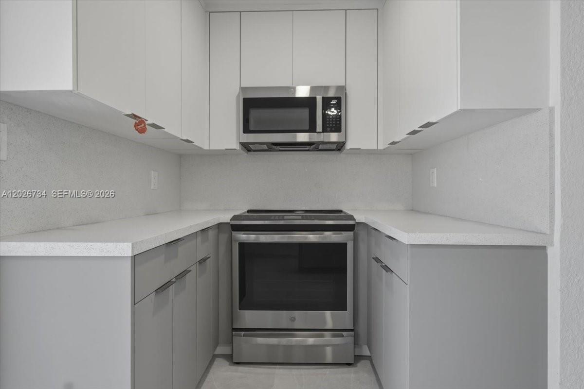 266 Southwest 6th Street Dania Beach, FL 33004 - Photo 23 of 37 a kitchen with a stove and microwave
