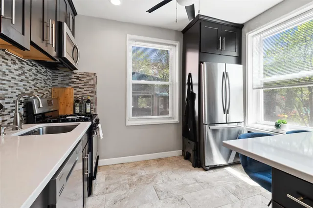a kitchen with a stove a sink and a refrigerator