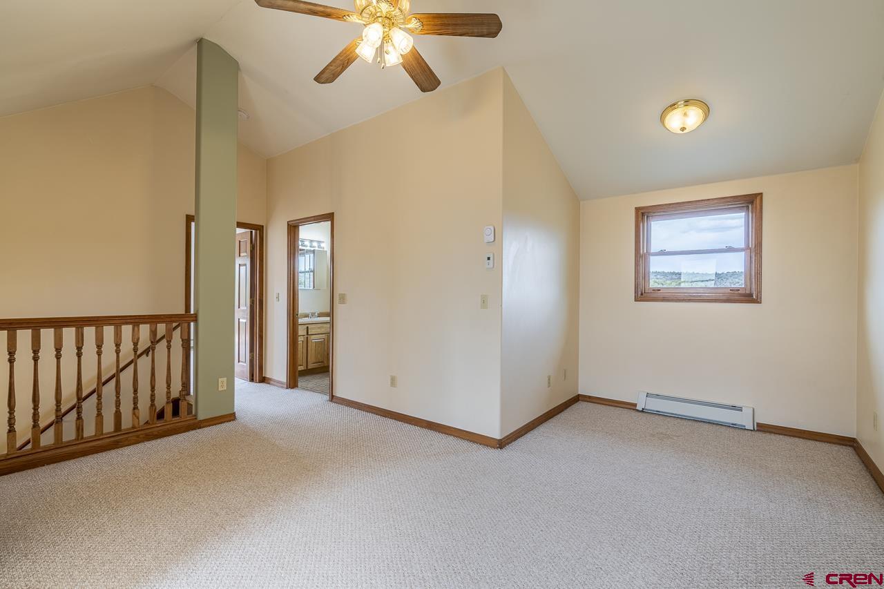 1403 Skyview Road Bayfield, CO 81122 - Photo 12 of 35 an empty room with chandelier fan