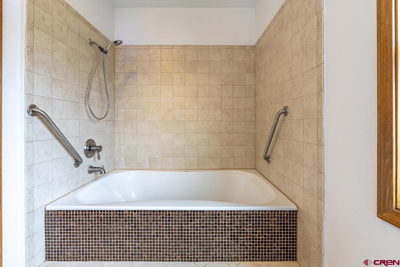 1403 Skyview Road Bayfield, CO 81122 - Photo 20 of 35 a bathroom with a bathtub and shower
