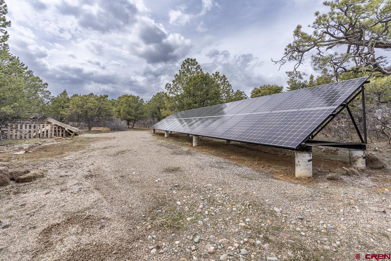 1403 Skyview Road Bayfield, CO 81122 - Photo 25 of 35 a view of a house with a yard and wooden fence
