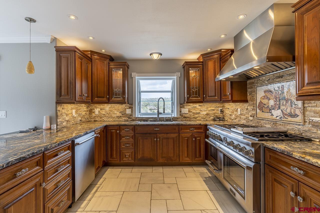 1403 Skyview Road Bayfield, CO 81122 - Photo 5 of 35 a kitchen with stainless steel appliances granite countertop a stove and a sink