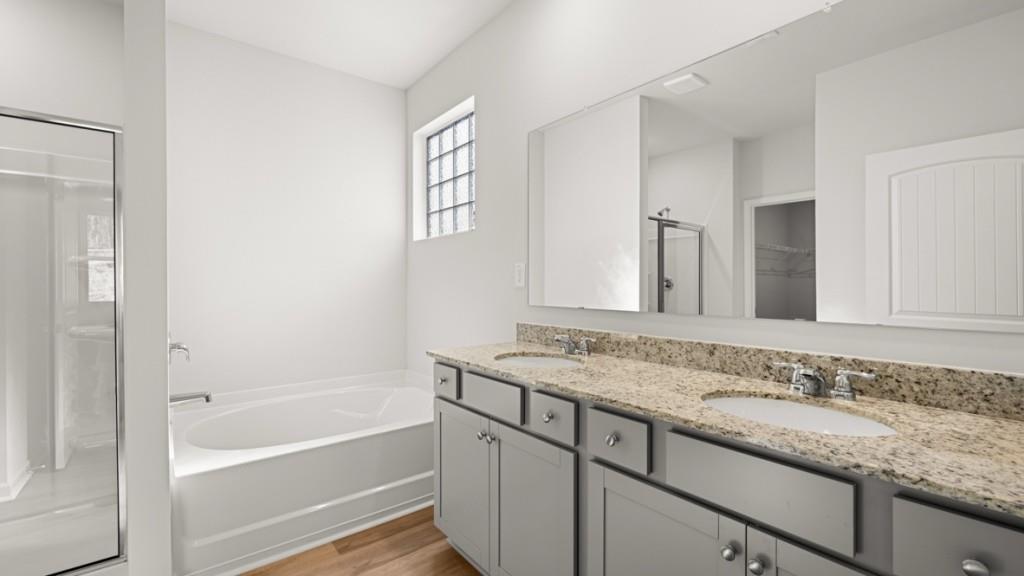 2930 Daxton Lane Gainesville, GA 30507 - Photo 18 of 32 a bathroom with a granite countertop sink and mirror with bathtub