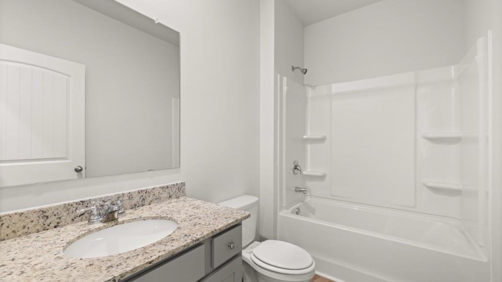 2930 Daxton Lane Gainesville, GA 30507 - Photo 27 of 32 a bathroom with a granite countertop sink toilet and shower