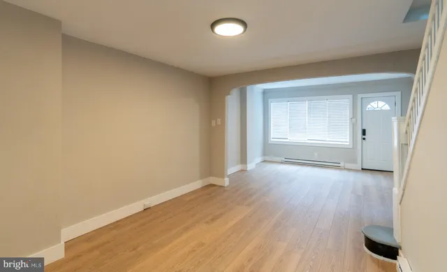 wooden floor in an empty room and a window