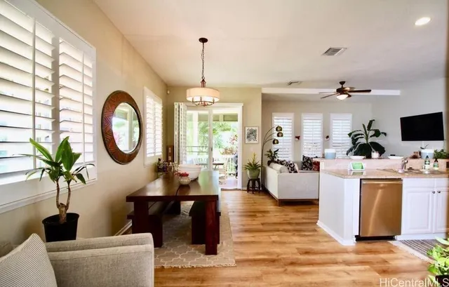 a living room with furniture a chandelier and a flat screen tv