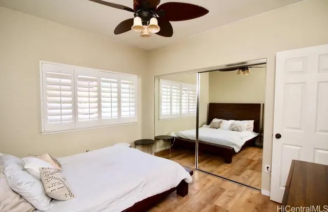 a bedroom with a bed couch and window