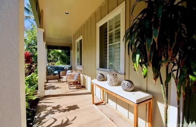 a view of a patio with table and chairs and potted plants
