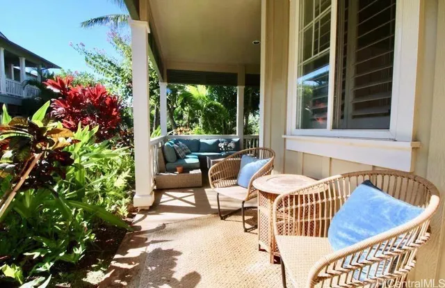 a view of a patio with couches table and chairs and potted plants