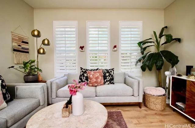 a living room with furniture and a potted plant