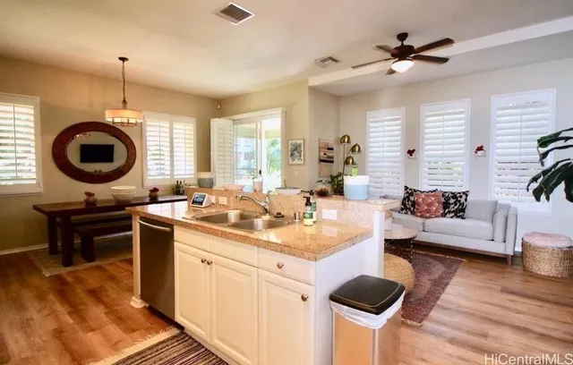 a kitchen with a stove a sink a dining table and chairs