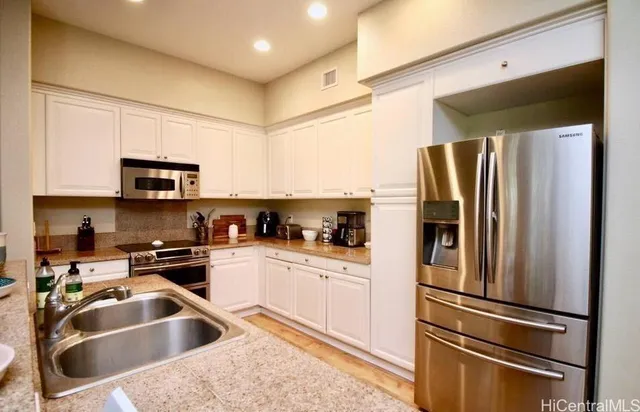 a kitchen with a refrigerator sink and microwave