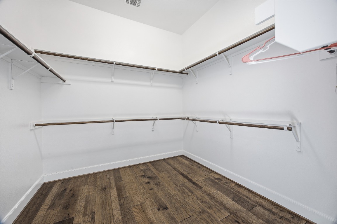 103 County Road 180, Unit 35 Leander, TX 78641 - Photo 19 of 31 Walk in closet with smart home panel, dark wood-style flooring