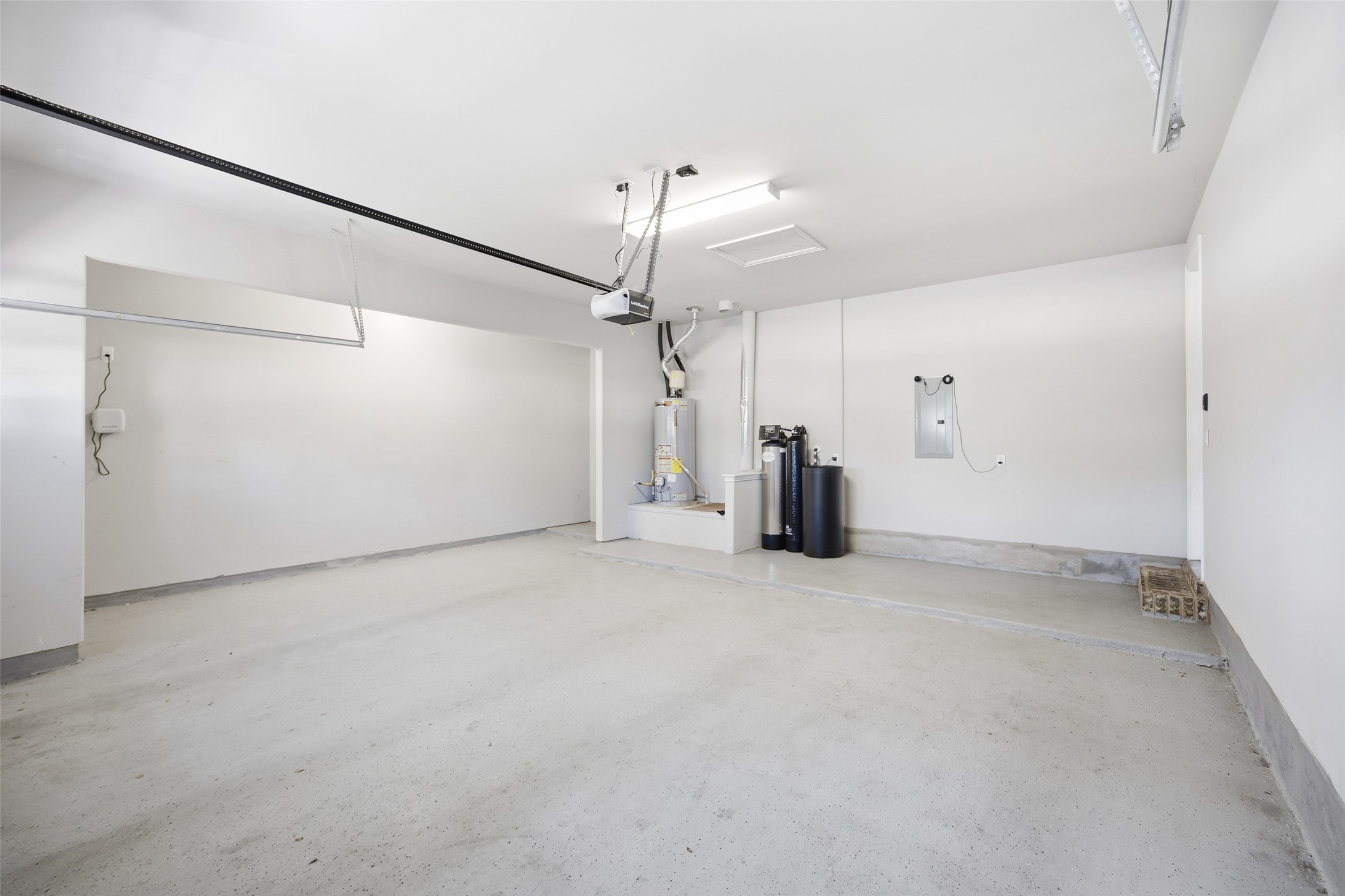 103 County Road 180, Unit 35 Leander, TX 78641 - Photo 26 of 30 Garage with electric panel, water heater and extra storage space