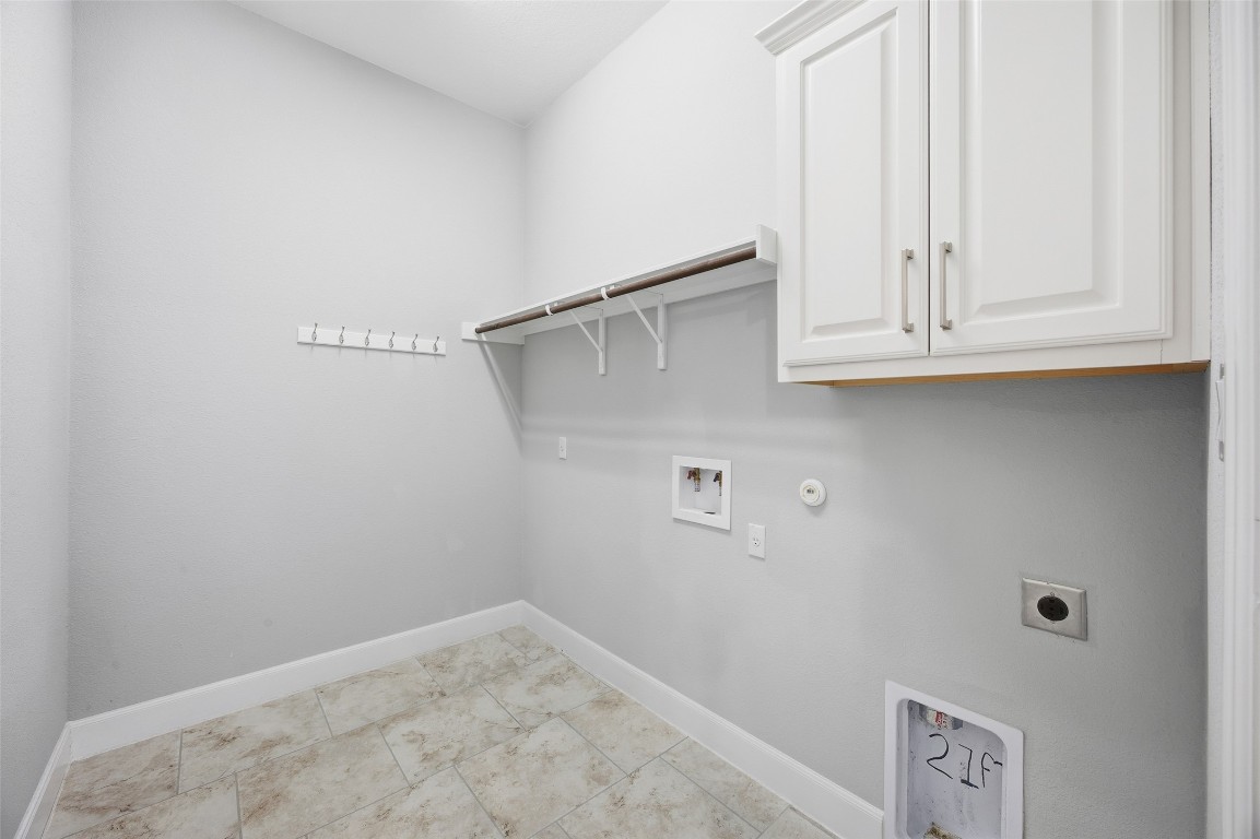 103 County Road 180, Unit 35 Leander, TX 78641 - Photo 26 of 31 Washroom featuring electric dryer hookup, hookup for a washing machine, and cabinet space