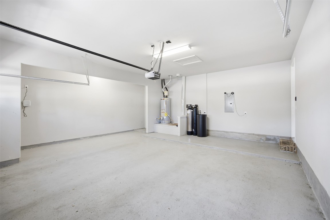 103 County Road 180, Unit 35 Leander, TX 78641 - Photo 27 of 31 Garage with electric panel, water heater and extra storage space