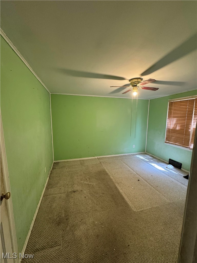 8133 Midland Road Mentor, OH 44060 - Photo 4 of 4 Carpeted empty room with a ceiling fan