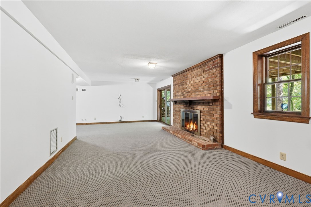 3201 East Brigstock Road Midlothian, VA 23113 - Photo 27 of 72 a view of a livingroom with an empty space and a fireplace