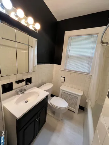 a bathroom with a sink toilet and mirror