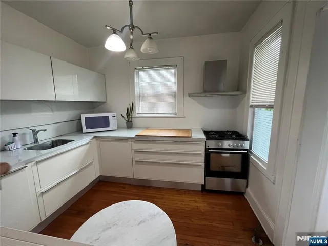 a kitchen with a stove oven and sink