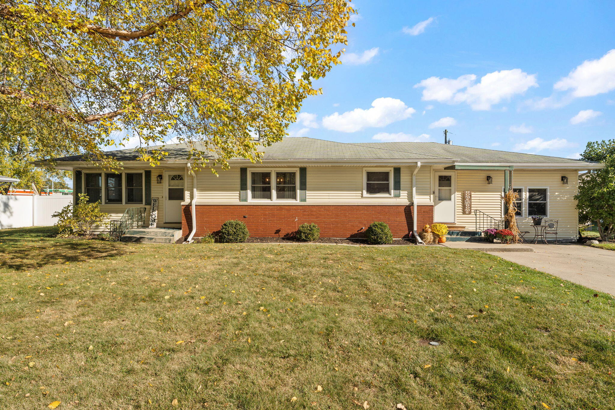 a front view of house with yard and trees around