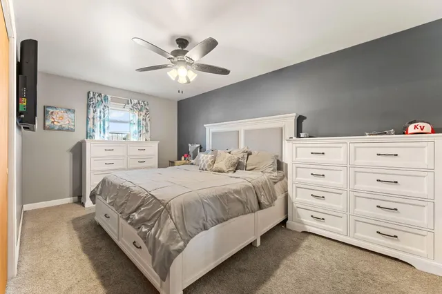 a bedroom with a large bed and a chandelier
