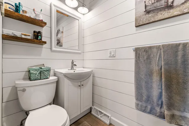 a white toilet sitting next to a bathroom sink