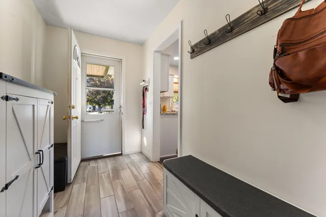 a view of hallway with wooden floor and stairs