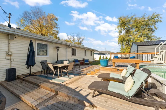 a view of a patio with couches table and chairs and potted plants