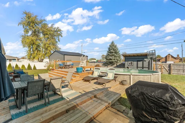 a view of a house with swimming pool and sitting area