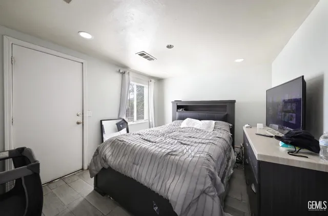 a bedroom with a bed and a television