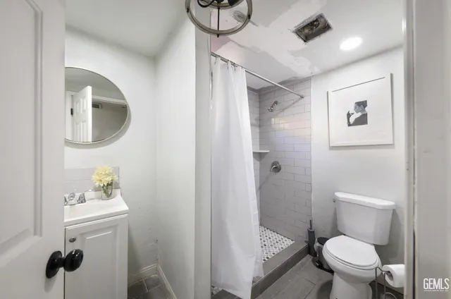a bathroom with a toilet sink and shower