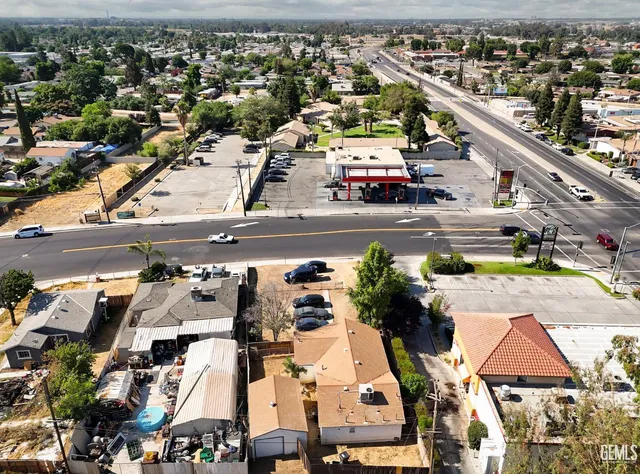 an aerial view of residential houses and car parked