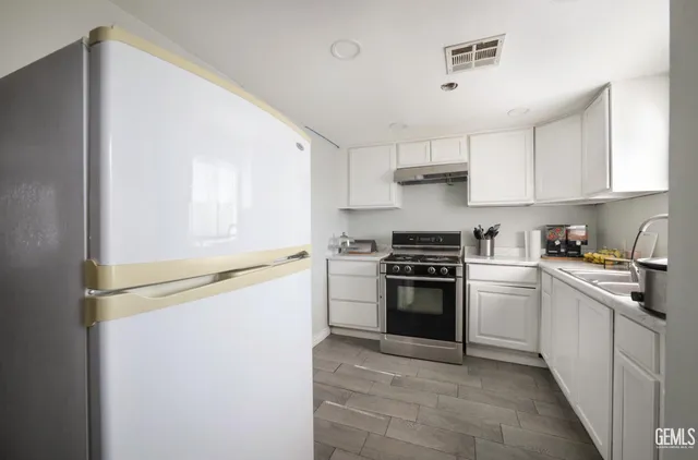 a kitchen with a stove and a refrigerator