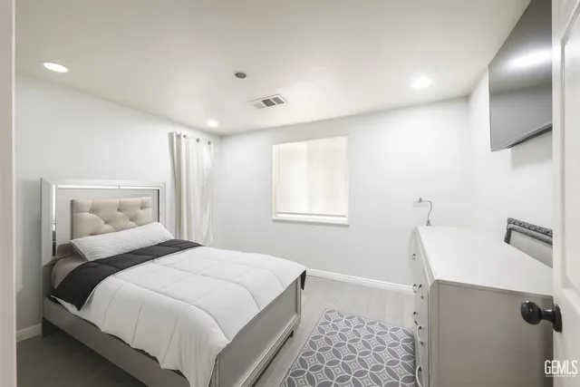 a bedroom with a bed and a sink